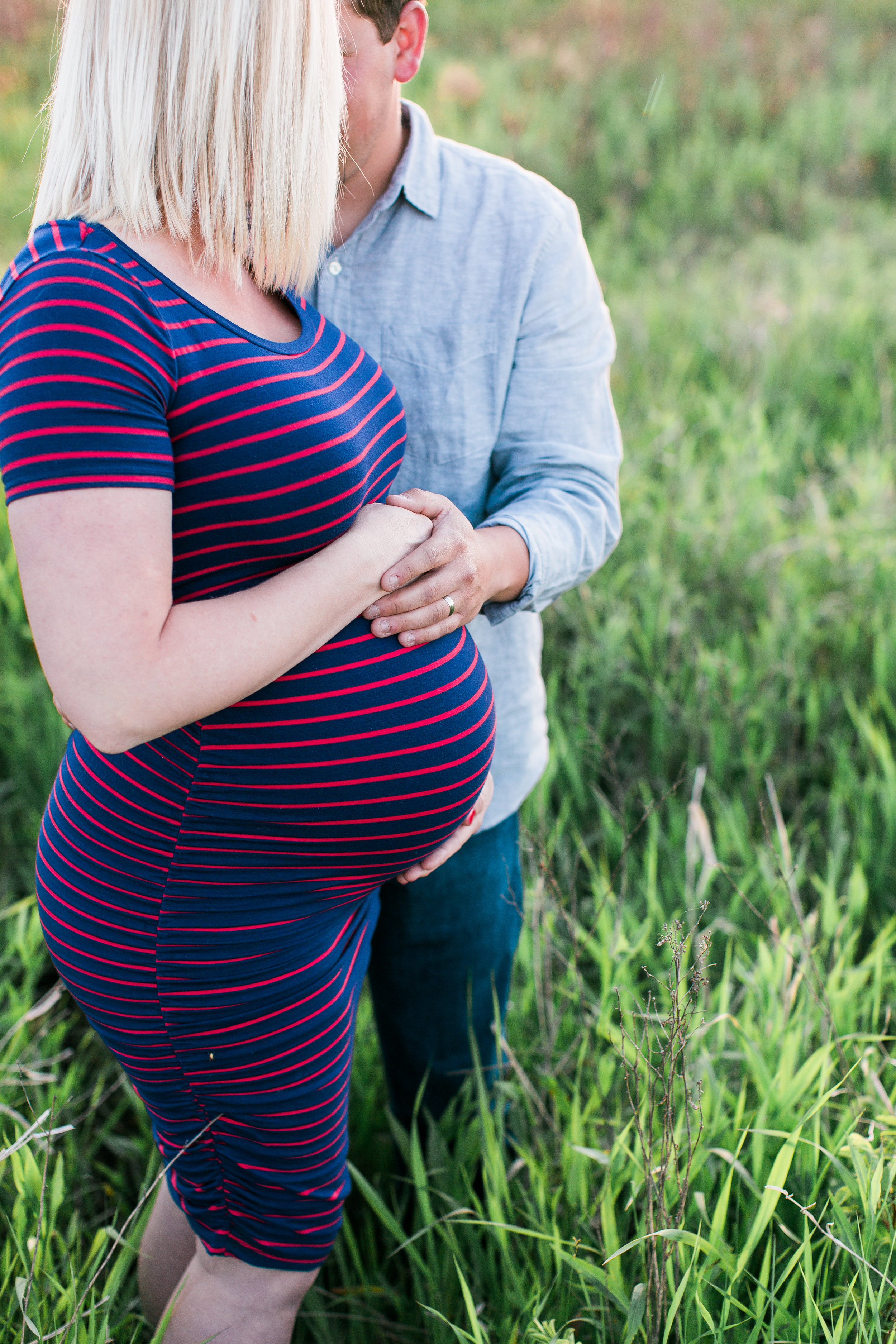 Summer maternity photo of bump mom and dad in rustic Minnesota field Minnesota maternity photographer Mallory Kiesow Photography