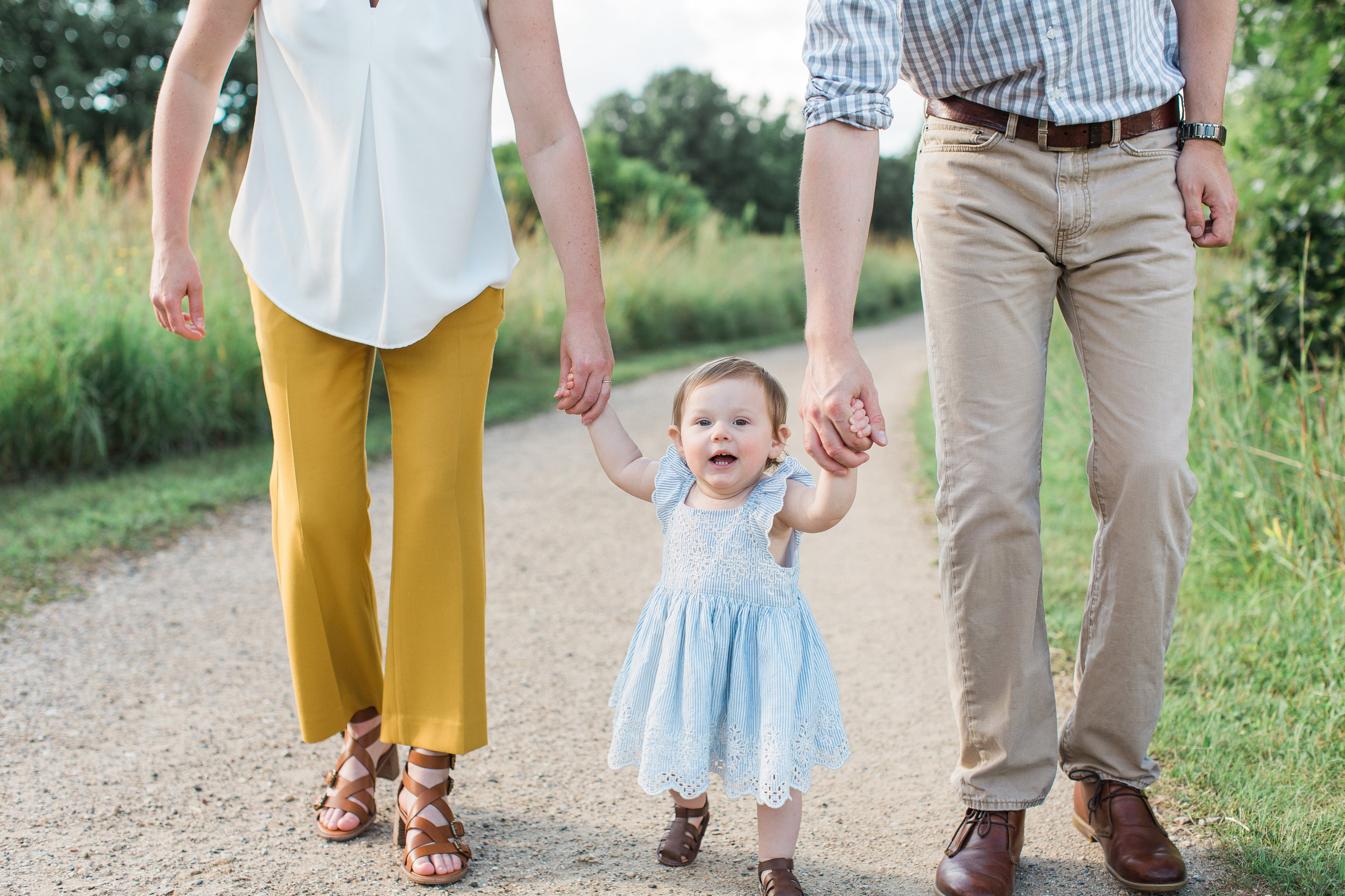 Minnesota family photograph of mom dad and toddler walking hand in hand one year photography Minnesota family photographer Mallory Kiesow Photography