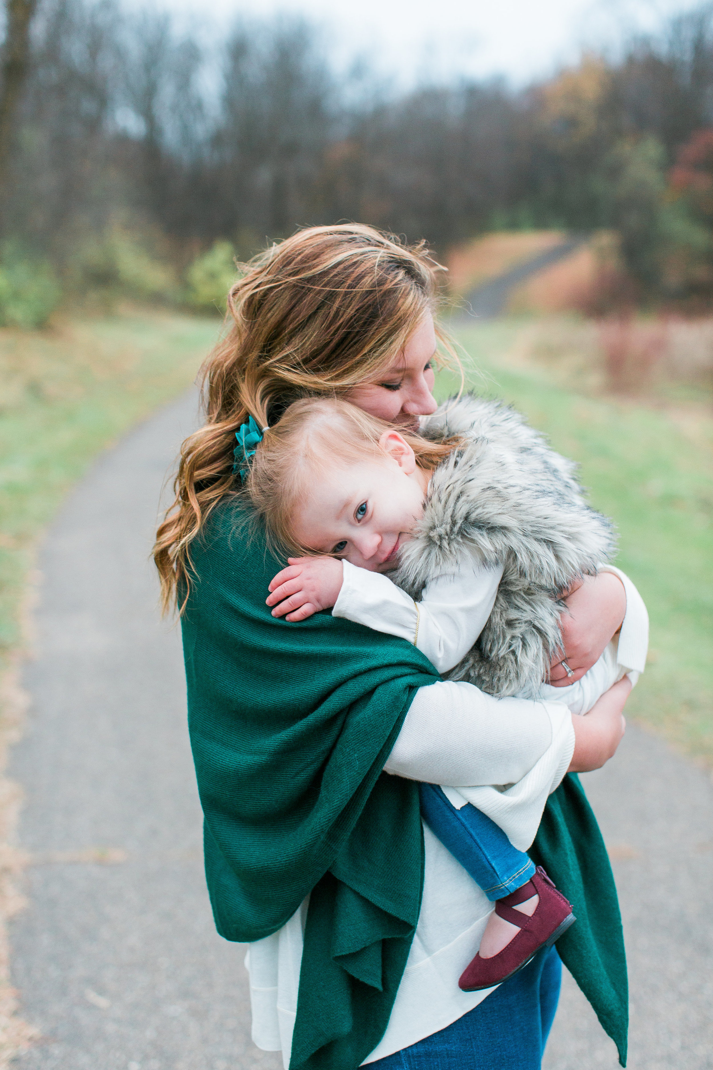 Mom and toddler hugging in lifestyle Minnesota family photo Minnesota family photographer Mallory Kiesow Photography