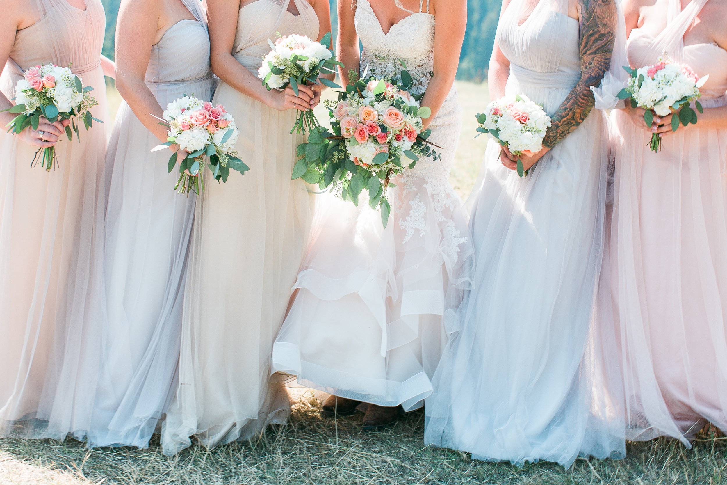 Bridesmaids in blush neutral dresses holding flowers Minnesota wedding photography mallory kiesow photography