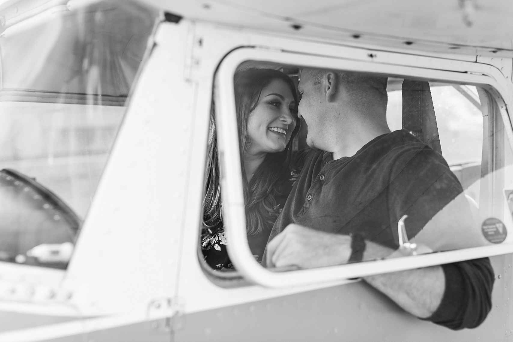Minnesota airplane engagement session flying cloud airport black and white couple in window
