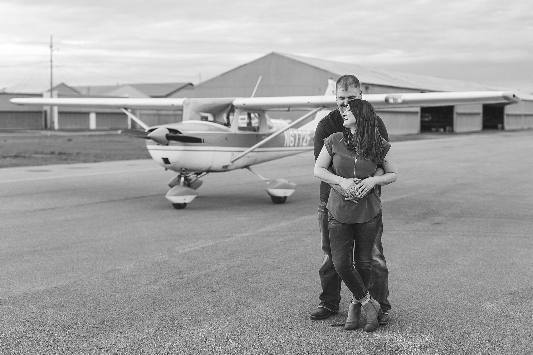 Minnesota airplane engagement session flying cloud airport black and white couple in front of airplane