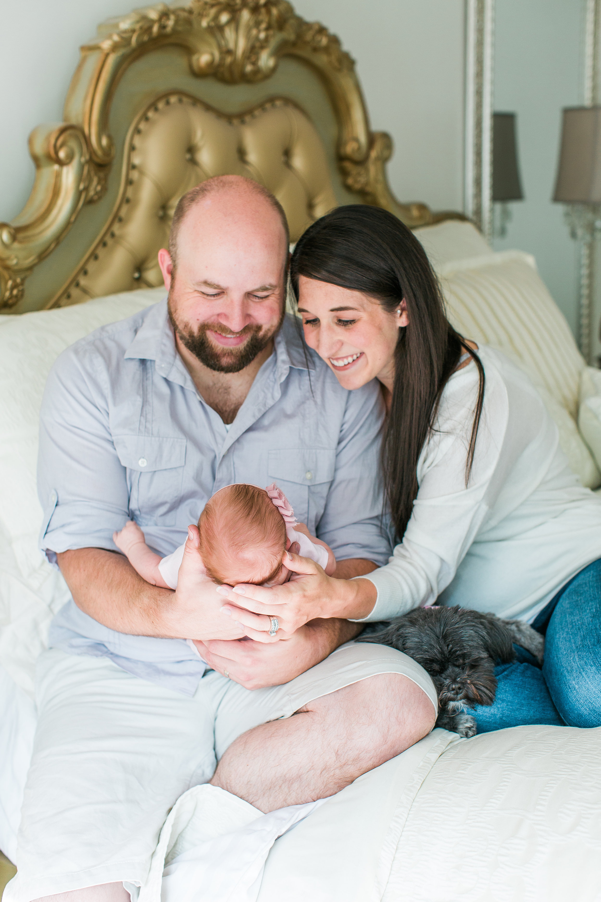 New parents admiring newborn baby girl in bedroom for lifestyle in-home newborn session Minnesota newborn photographer Mallory Kiesow Photography