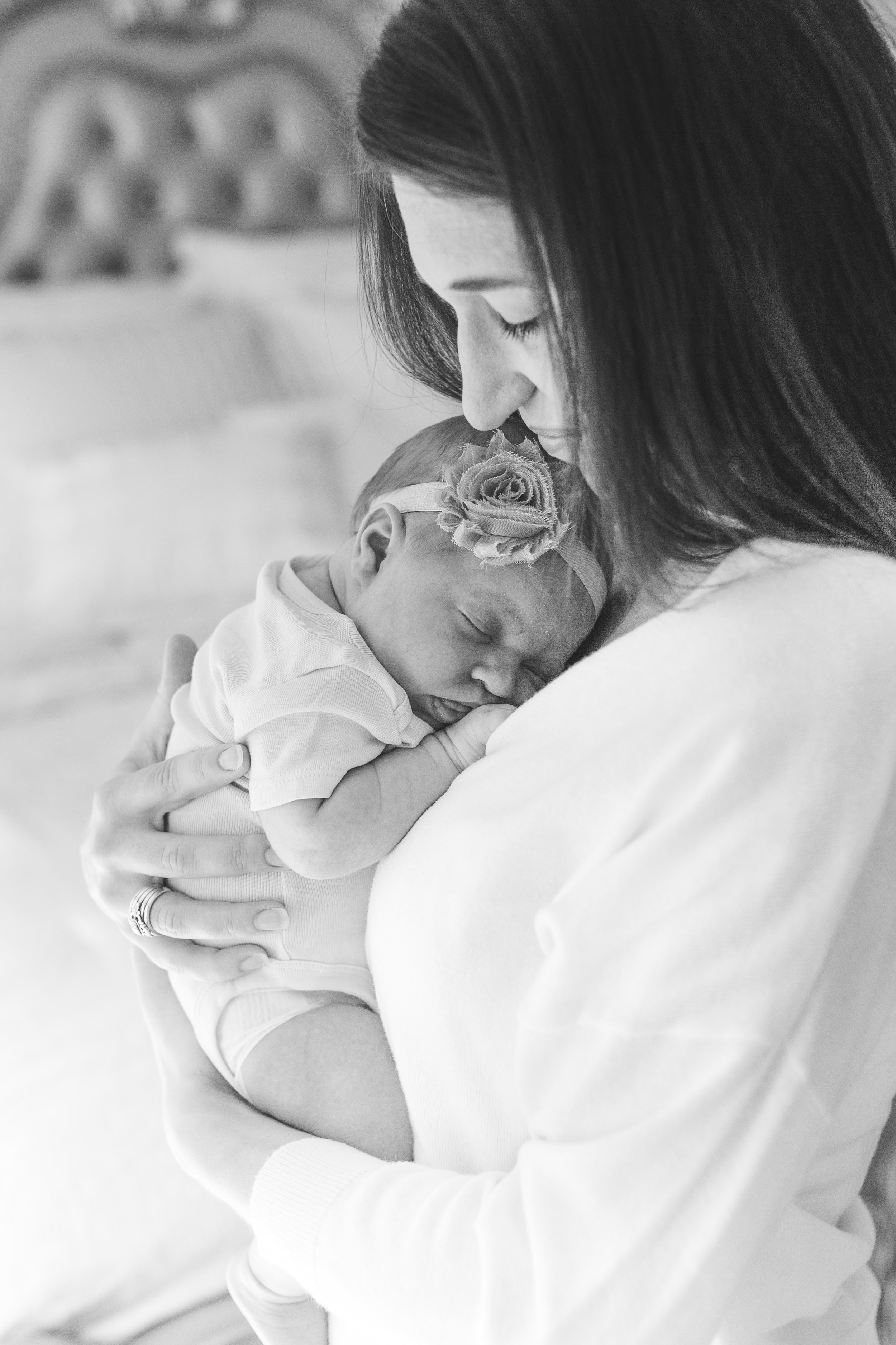 Mom and newborn baby black and white photo in bedroom in lifestyle newborn in-home session Minnesota newborn photographer Mallory Kiesow Photography