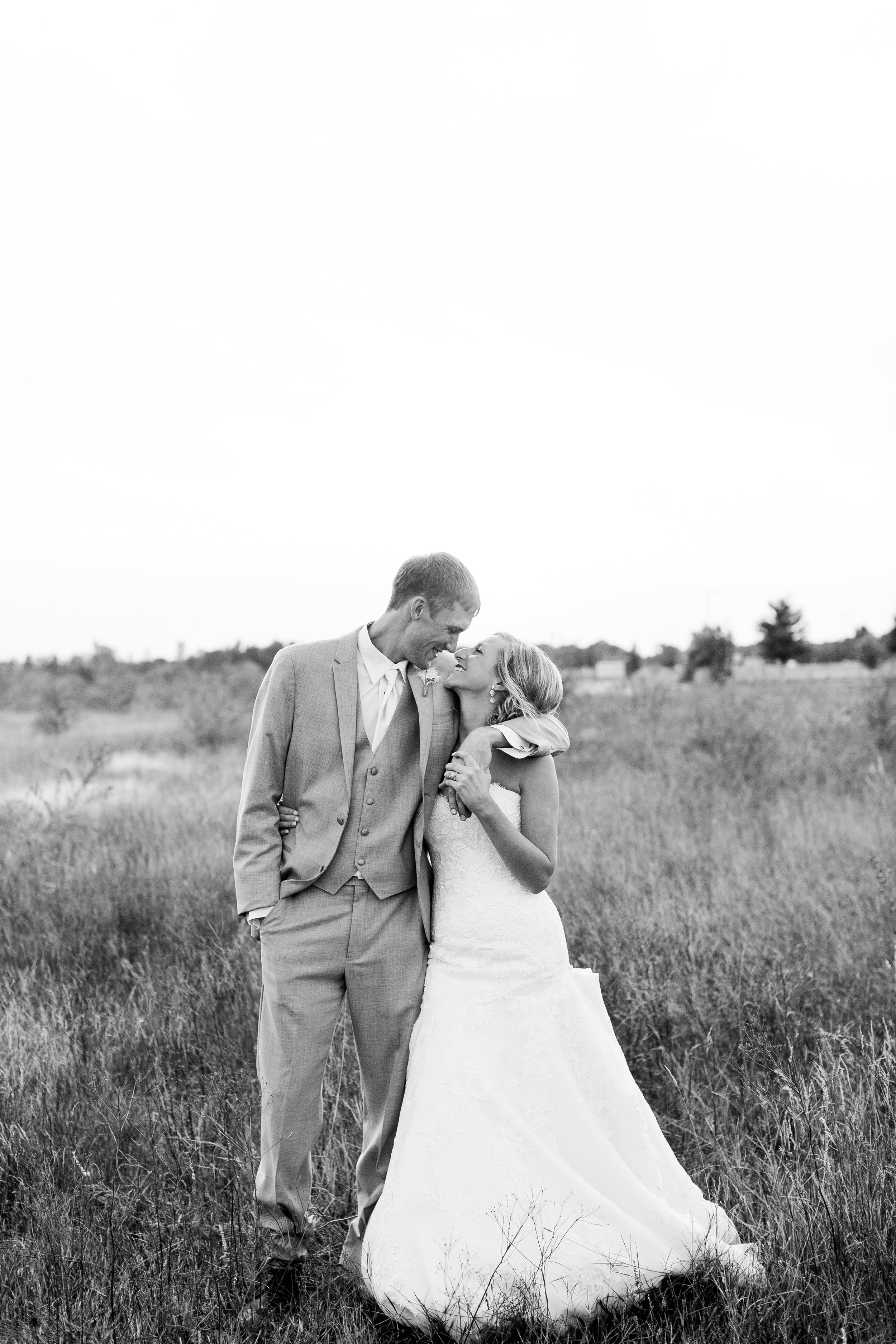 Bride and groom kissing in field in black and white Buffalo Minnesota wedding Minnesota wedding photography Mallory Kiesow Photography 