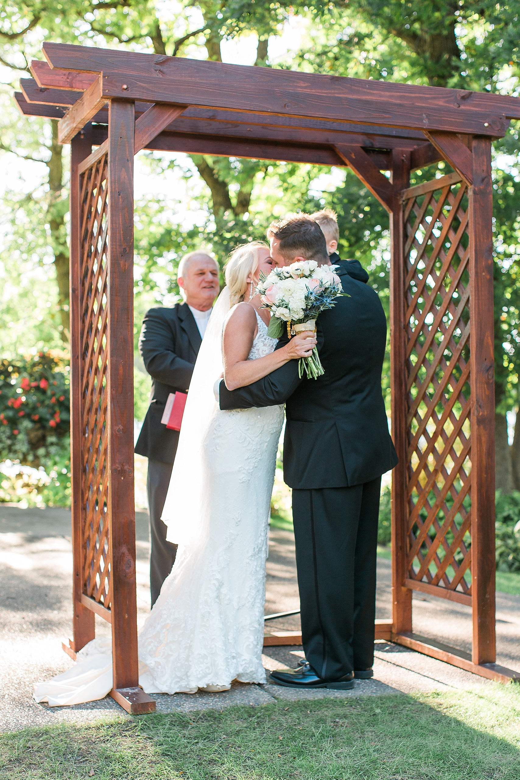 Outdoor wedding ceremony kiss at the Chart House Summer Wedding Lakeville Minnesota Minneapolis Wedding Photographer Mallory Kiesow