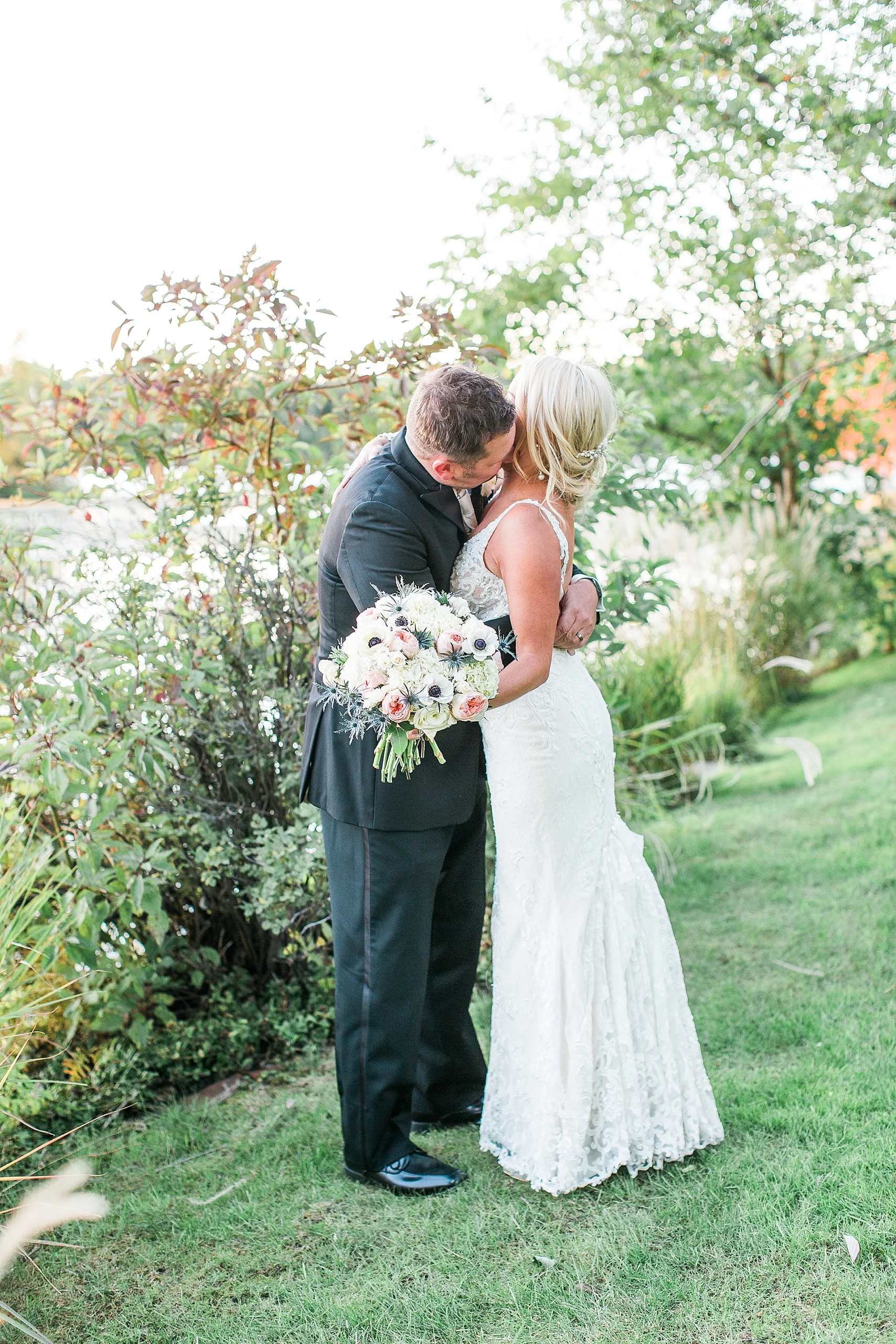 Bride and groom sunset golden hour portrait embrace at the Chart House Summer Wedding Lakeville Minnesota Minneapolis Wedding Photographer Mallory Kiesow