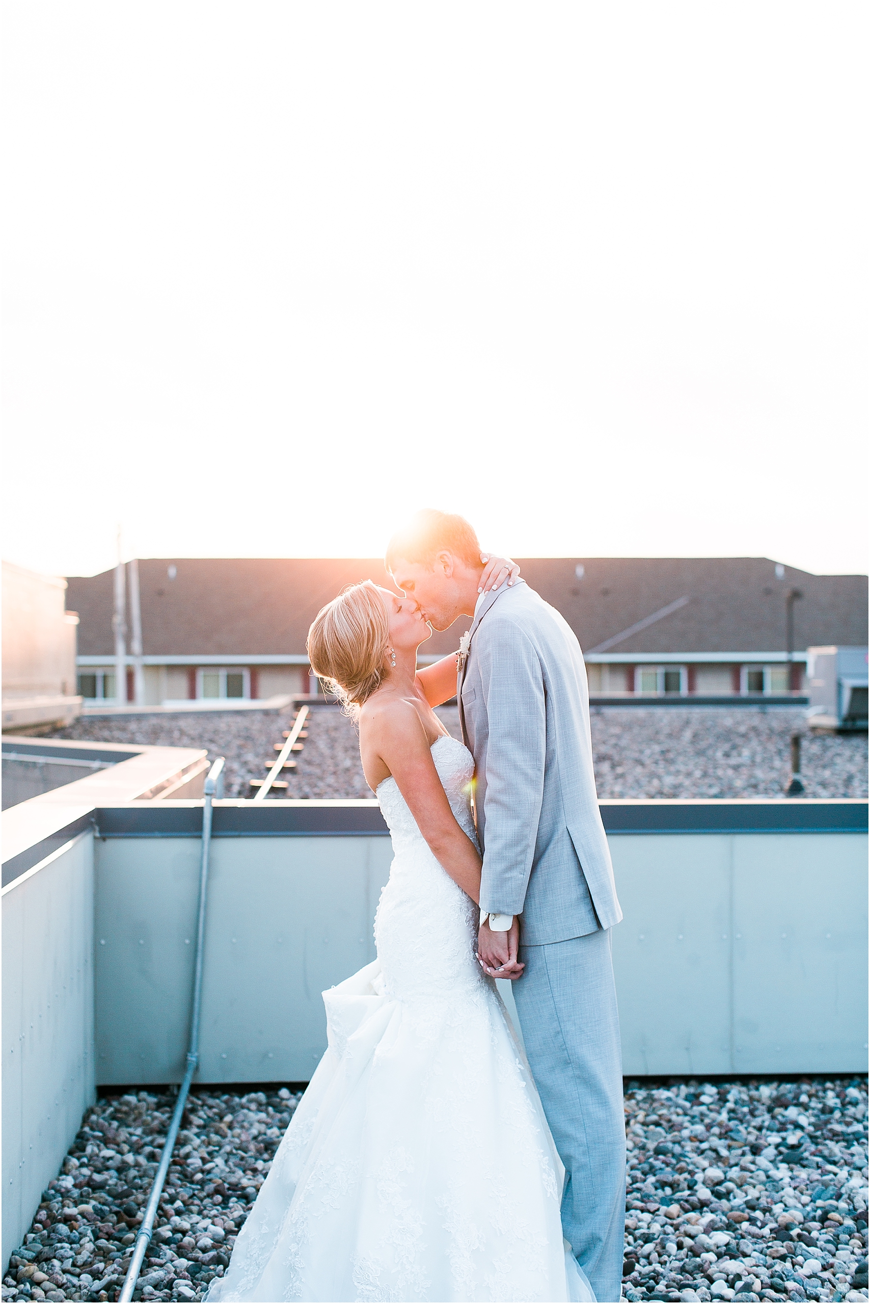 Bride and groom sunset rooftop portrait outside at Minnesota summer wedding in Buffalo MN photographed by Mallory Kiesow, Minnesota wedding photographer