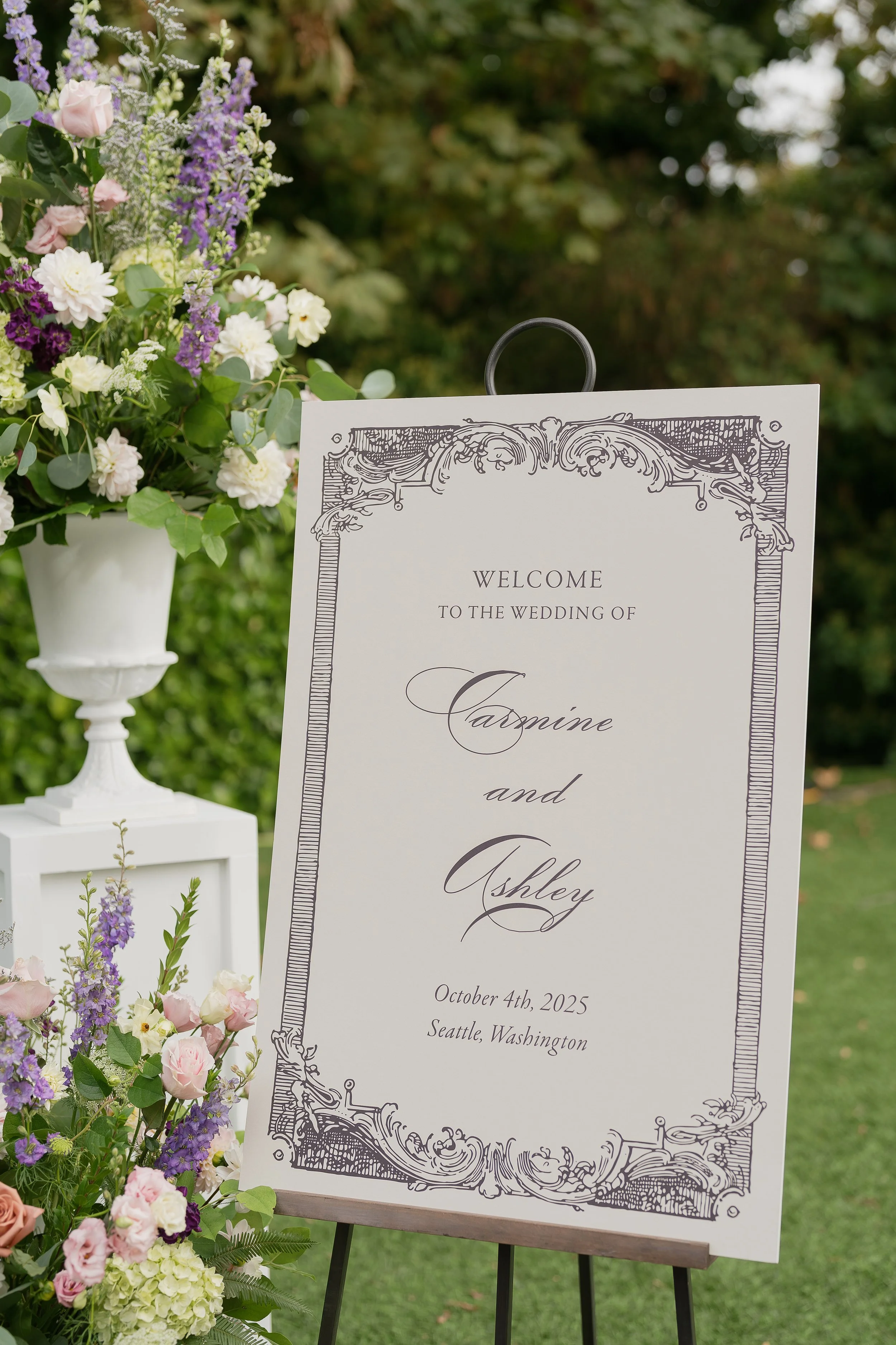 Modern wedding signage with bold typography next to vibrant floral arrangements, showcasing a blend of traditional and contemporary wedding styles.