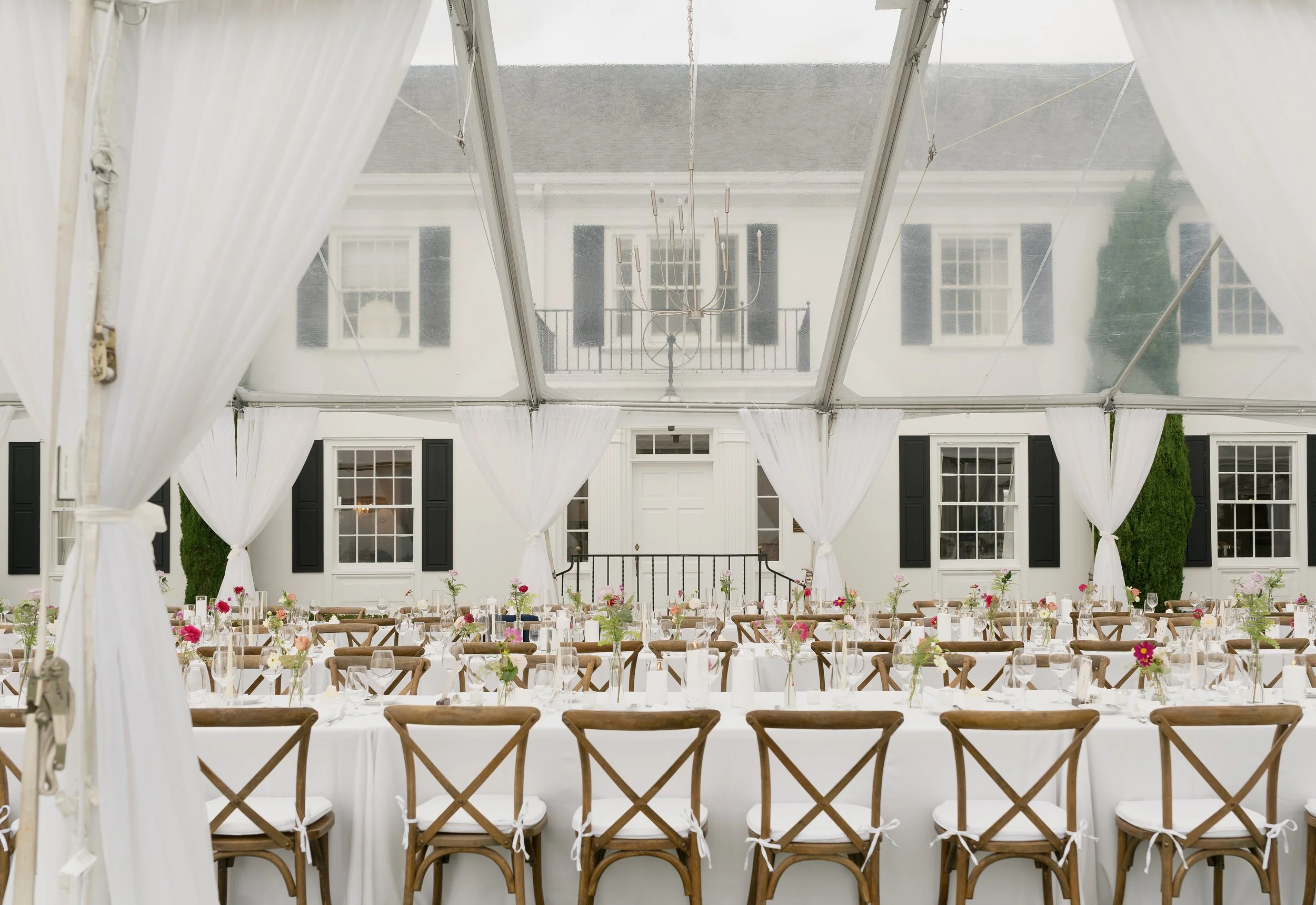 Garden wedding dinner setting with historic building