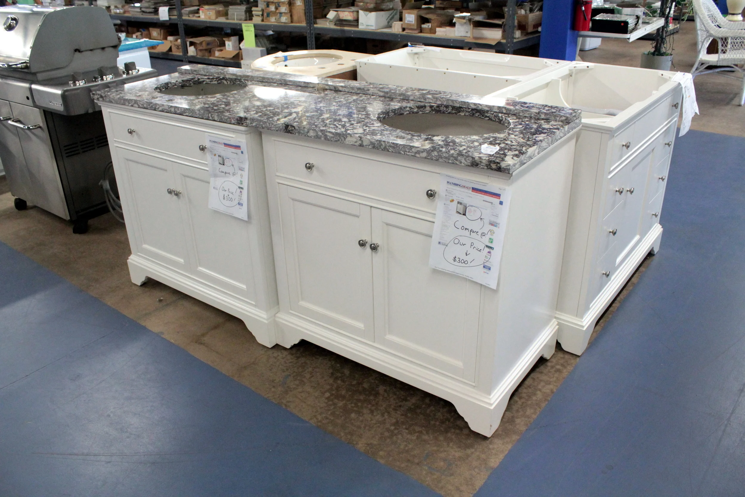 SOLD! White and Granite Double Sink Vanity for only $300. We are looking for items like this! Donate today!