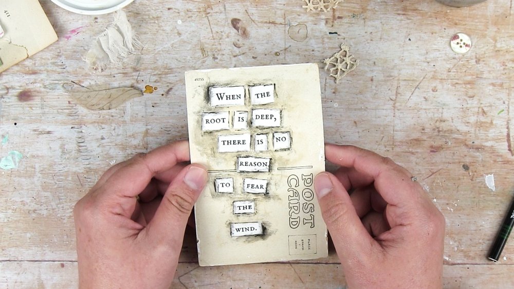 Cut-out words on a postcard