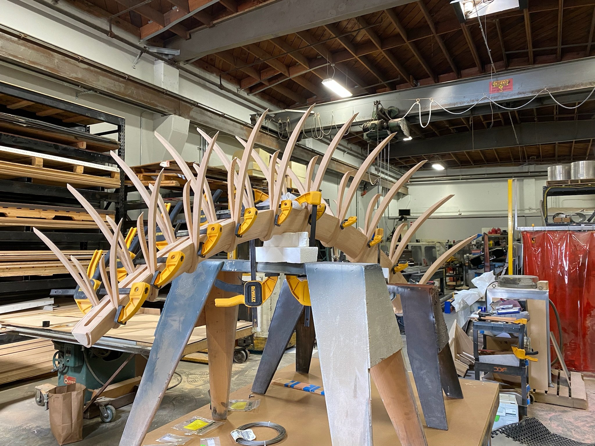 Stack of precision CNC-milled single-ply Douglas fir wood veneer fins in the workshop.