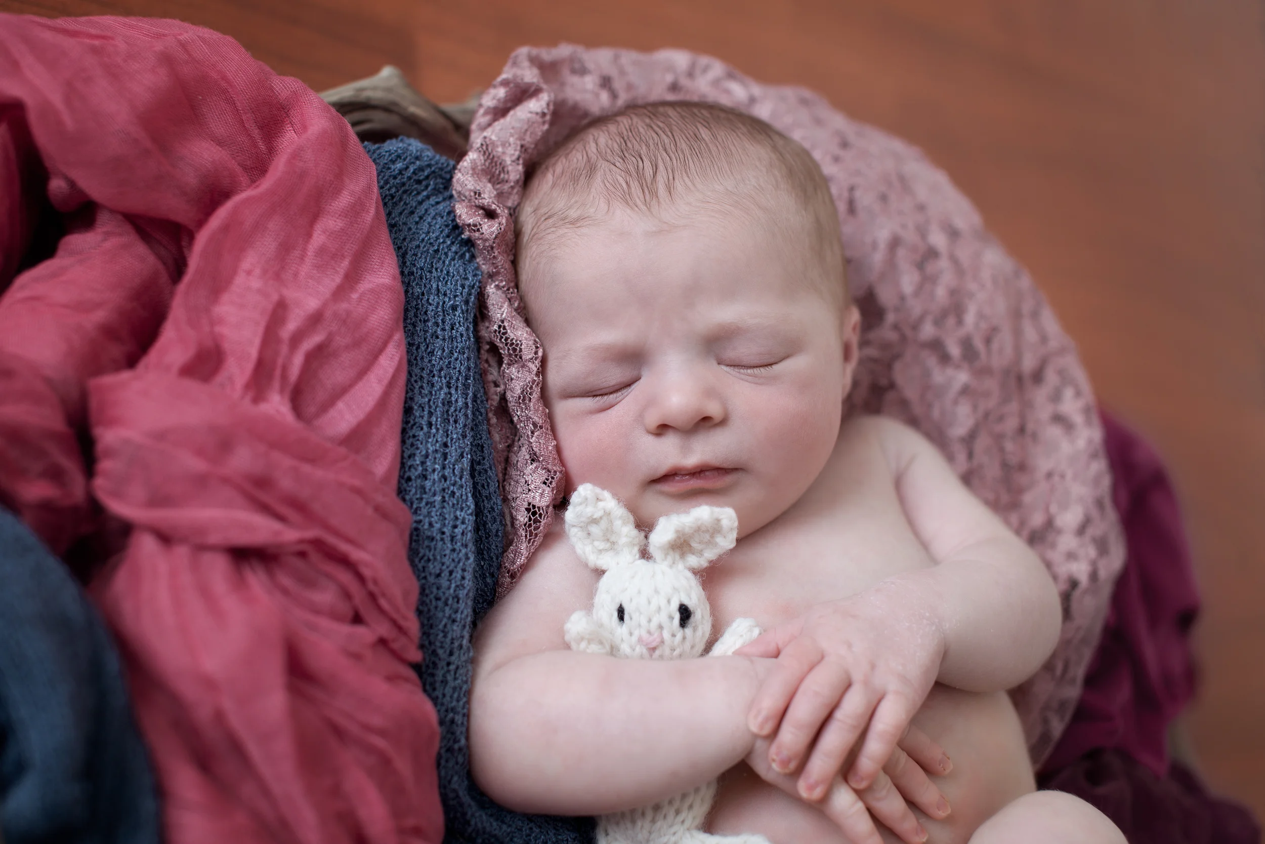 Columbus, Ohio photographer, Professional Portrait Studio, newborn photography. Infant in pink wraps with bunny. 