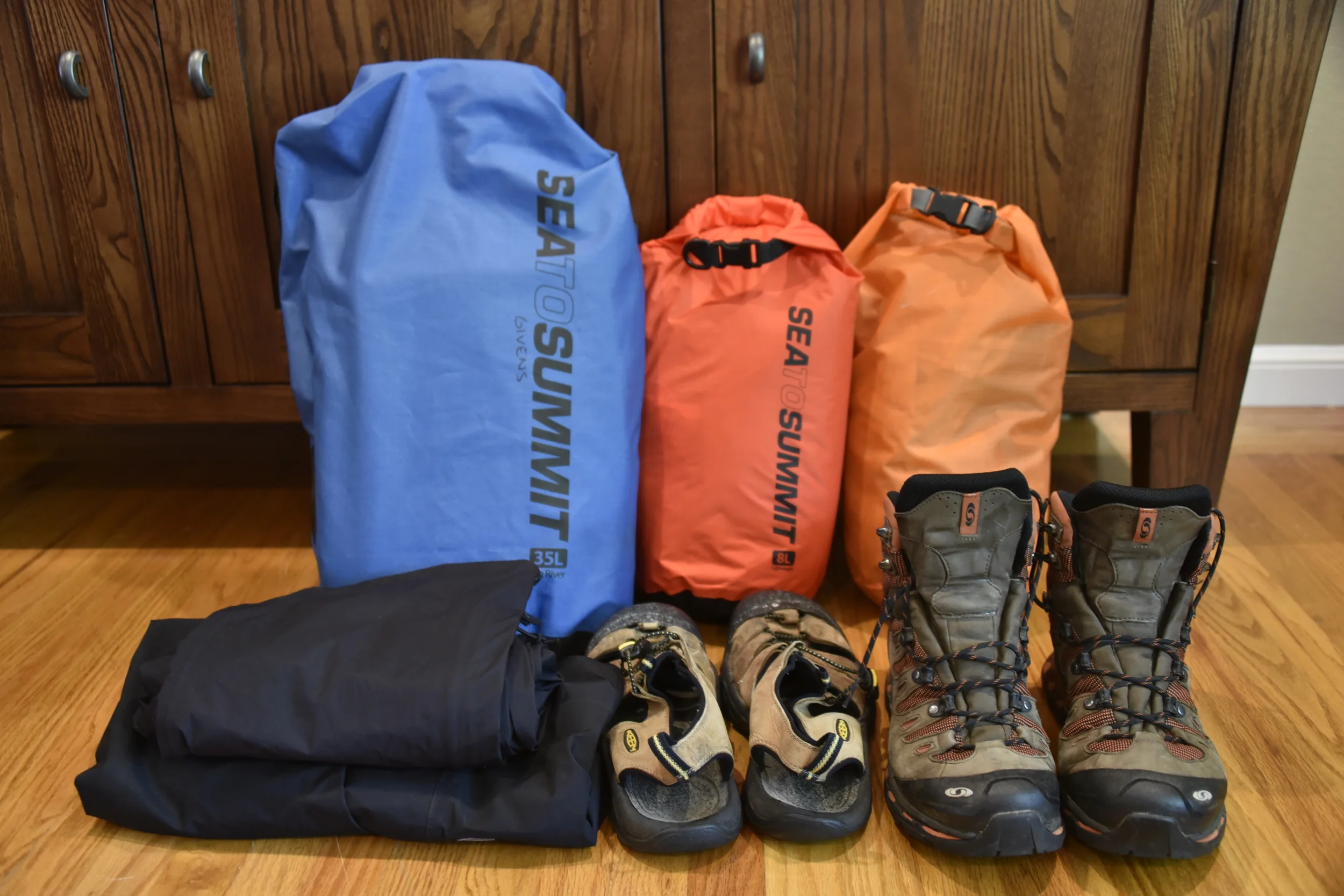 Waterproof bags to hold clothes and sleeping bag. Plus boots, sandals, and waterproof outer layer pants/jacket.
