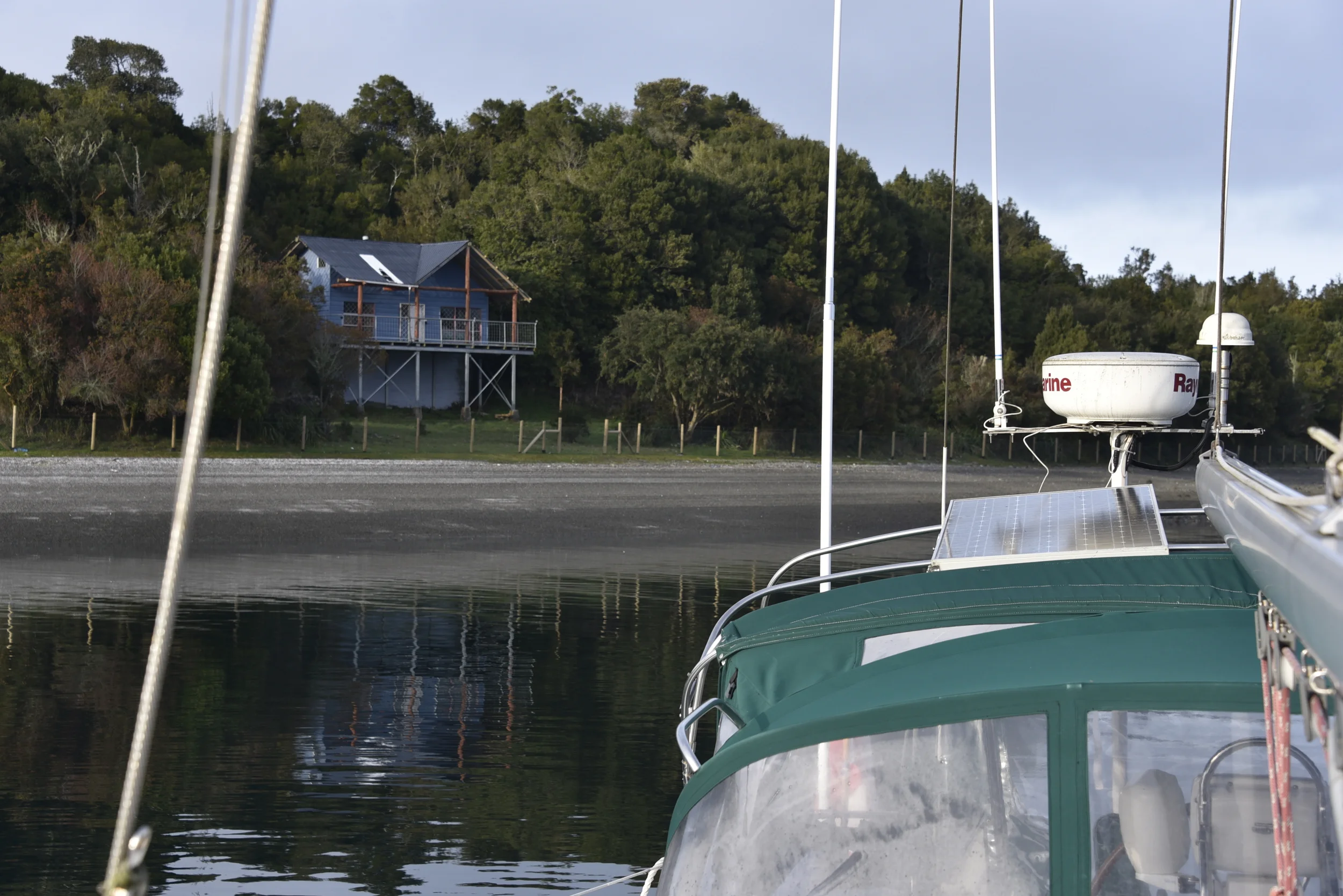 A view of the family vacation cottage on the shore of Isla Puluqui. (Photo taken from bow of Kaweskar in the foreground.)