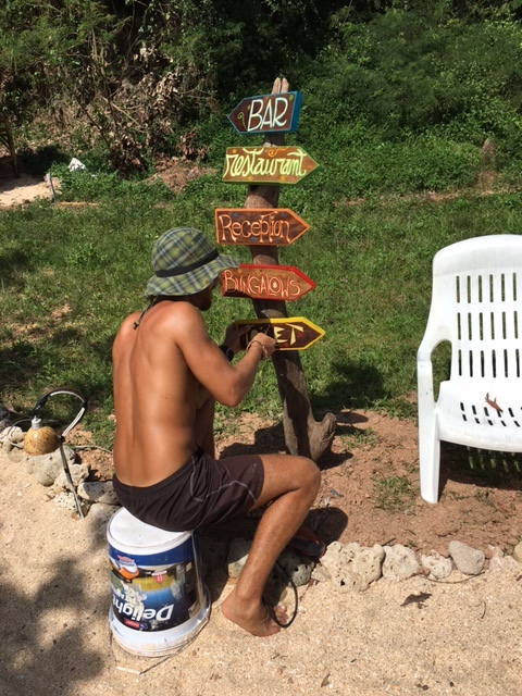 Installing the colorful signs on the signpost.