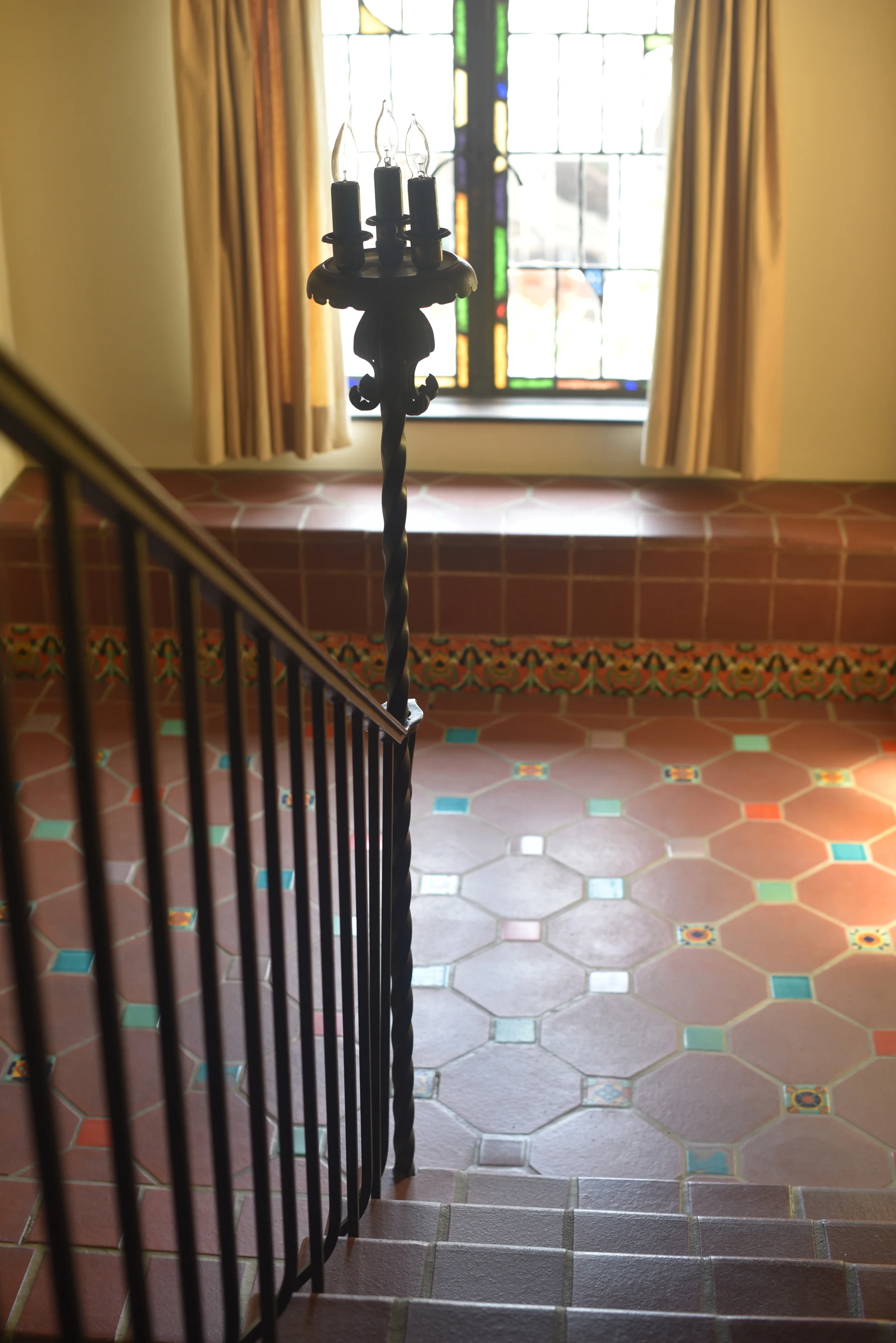 Our tile stairs. We used to come down these in our pajamas on Christmas morning. We would pause on the landing, shown here, and peer over the wrought iron railing looking down into the living room. My parents would be in the living room below and film us. Those old home movies are somewhere now converted to DVD...I hope.