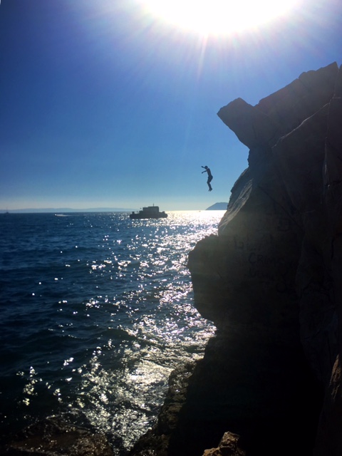 Cliff diving is a popular activity along the coast.