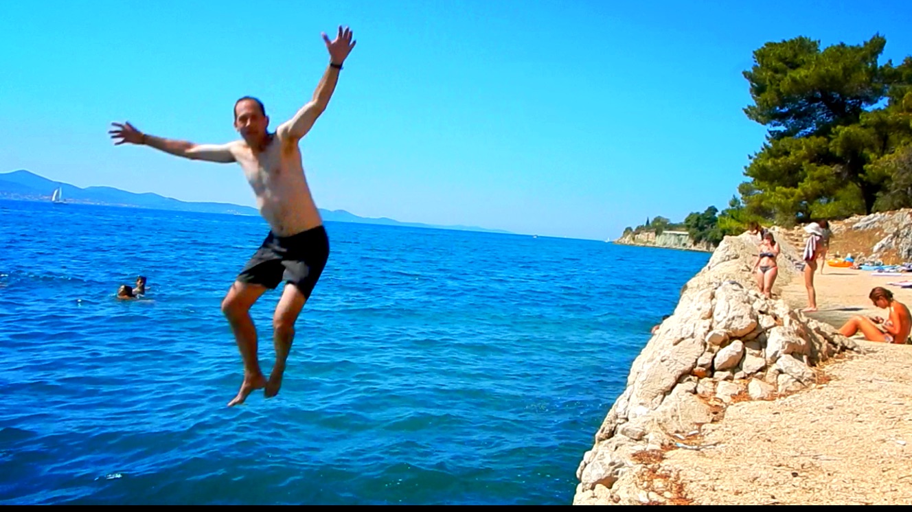 Jumping off a small cliff into the Adriatic Sea for the first time. Warning: Don't zoom in - beware the farmer's tan and executive's body.