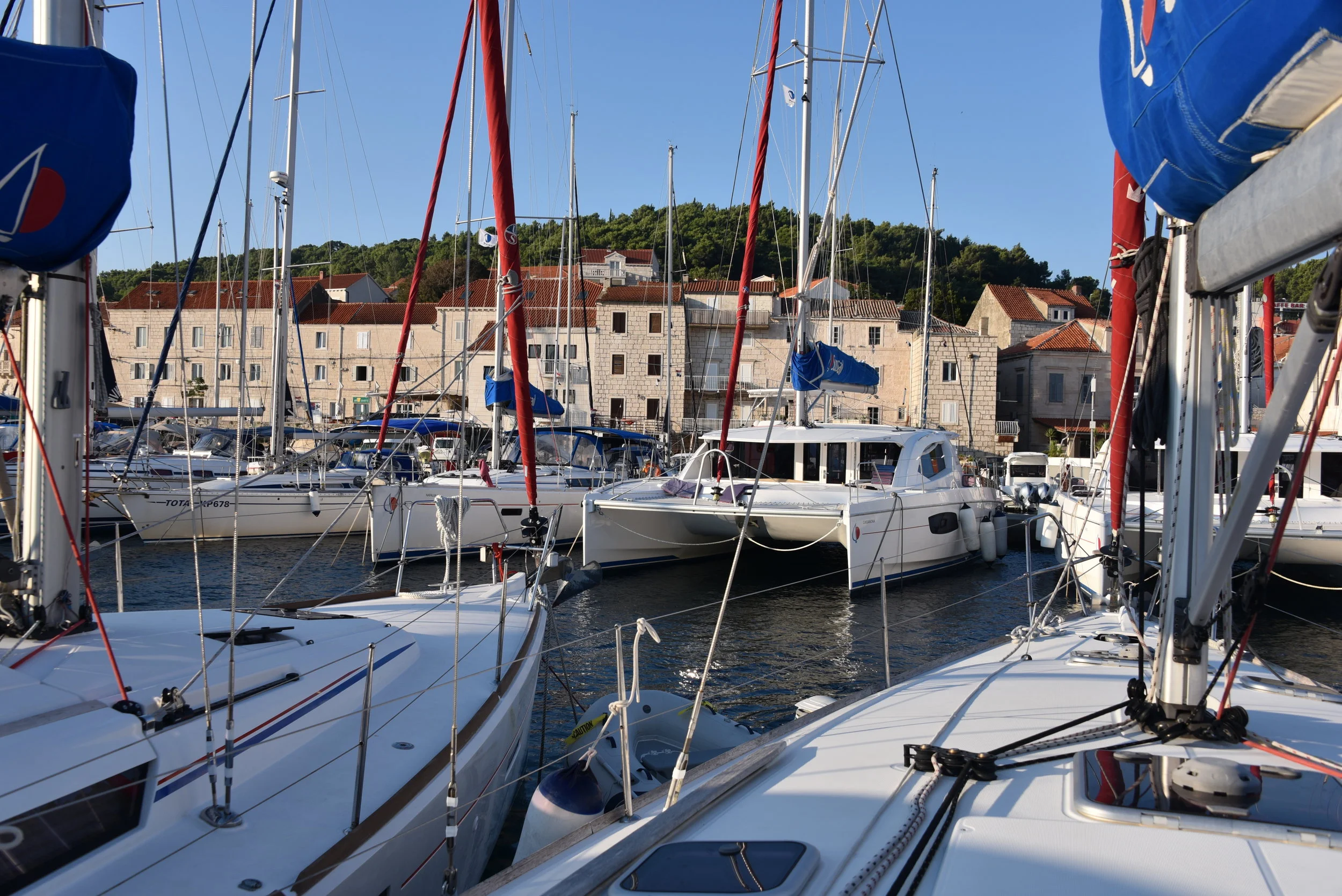 Very close quarters in the marina at Korcula! We used a spring line in our departure with wind blowing 10 knots. The spring line enabled us to make a very sharp turn to the left, before we hit those big catamarans staring us down. :-)