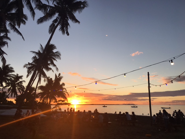 Enjoying the sunset on the beach while eating dinner.