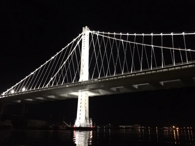  Enjoying a night sail... under a bridge, under a full moon, under a shooting star, and unfortunately, under the weather. 