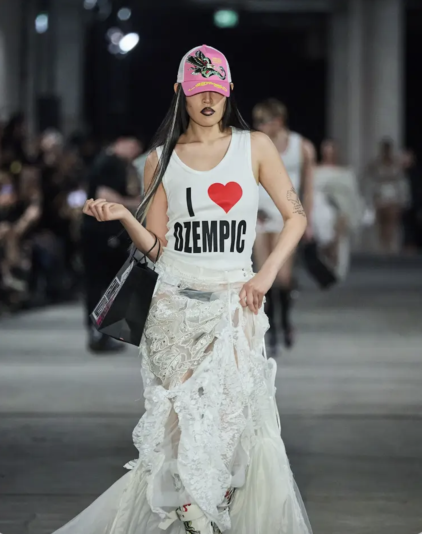 Model walking in a Berlin Fashion Week show in 2024; the image accompanied a Vogue article.