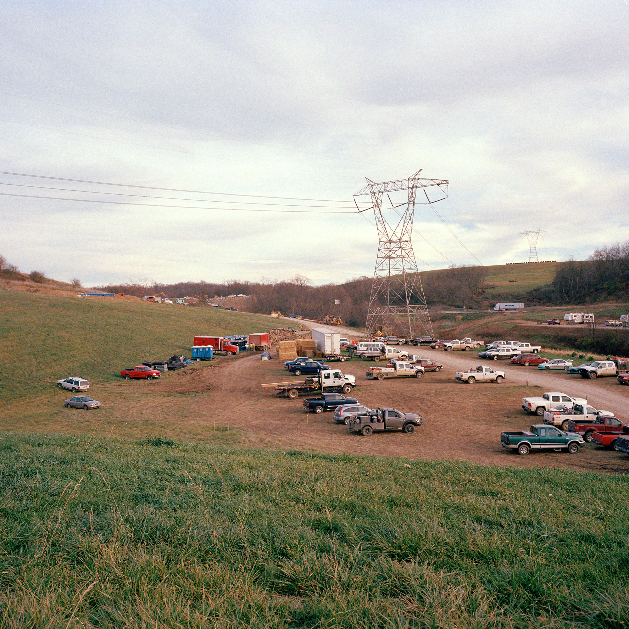 Power lines run over a parking field for workers building a gas pipeline near Claysville PA