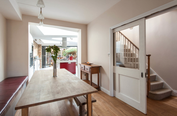 The home in this image illustrates the layer idea. You can see across a dining area (first layer), through the kitchen (second layer) and to a garden beyond (third layer). 