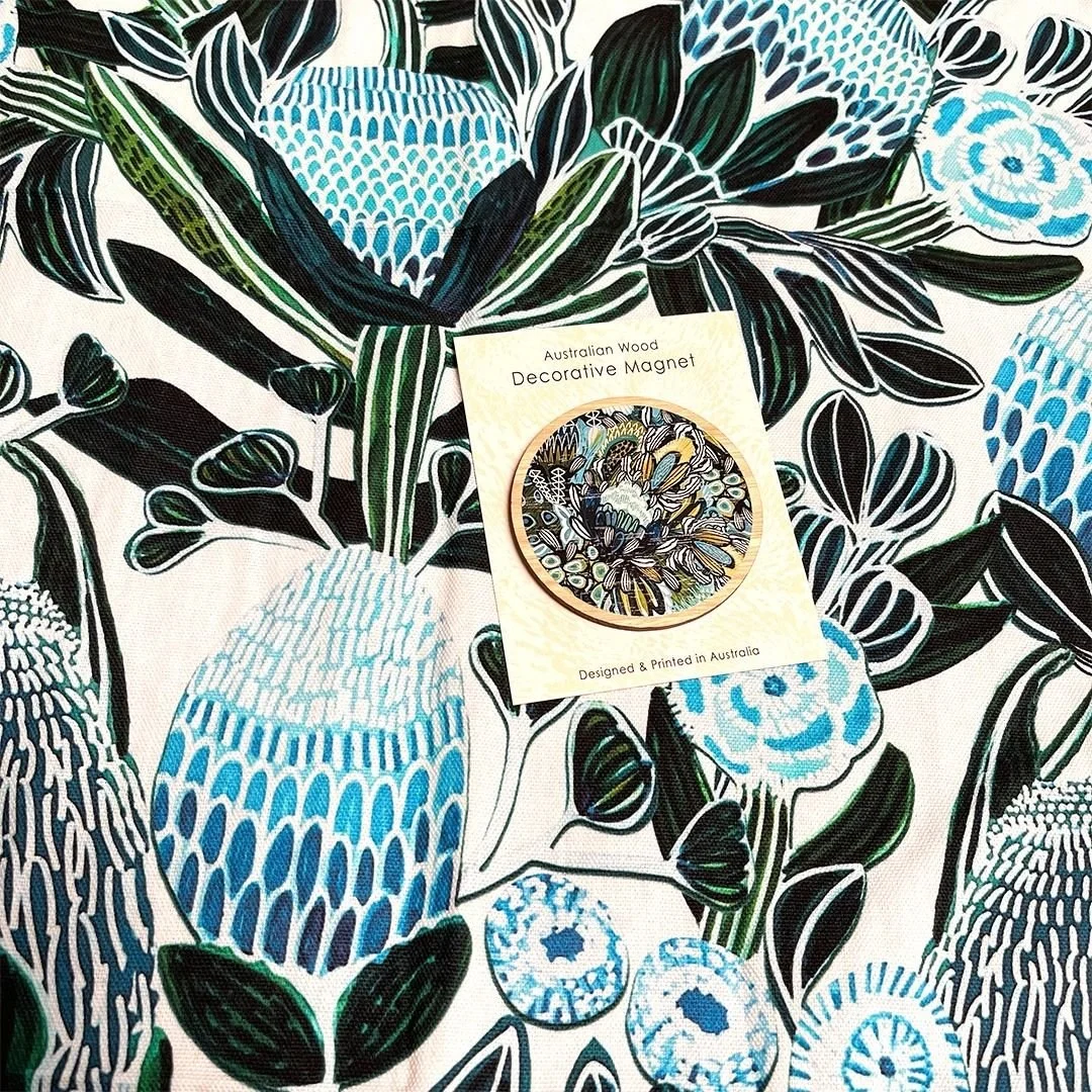 Add a stylish and modern touch to your kitchen with the Blue Banksia Tea Towel &amp; Magnet Set! This popular set features stunning original hand-painted artwork of banksias by Australian artist Kirsten Katz, printed on 100% cotton tea towel and a be
