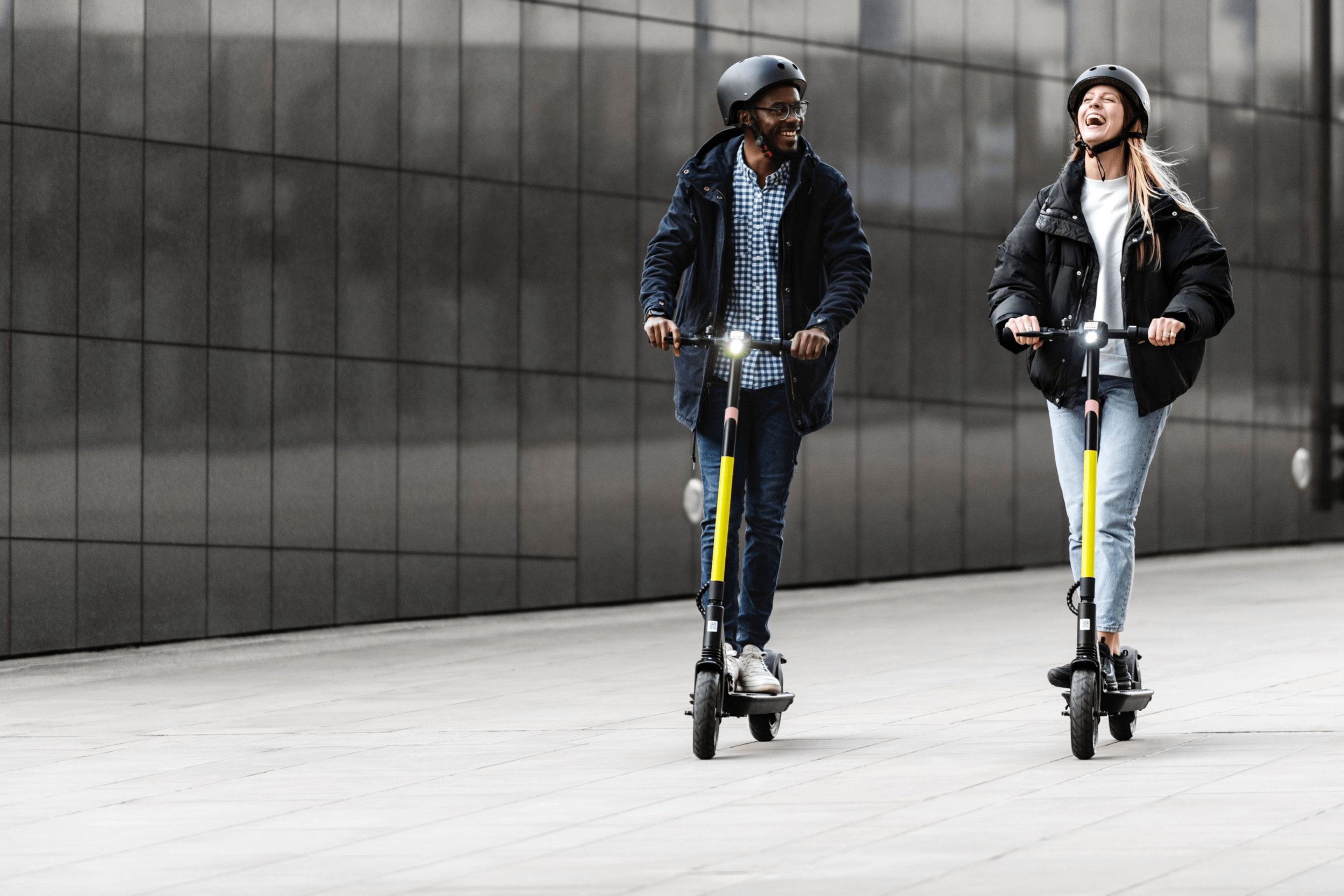 62d566f9bc83b9f15c40f89b_two people on dott scooters.jpg