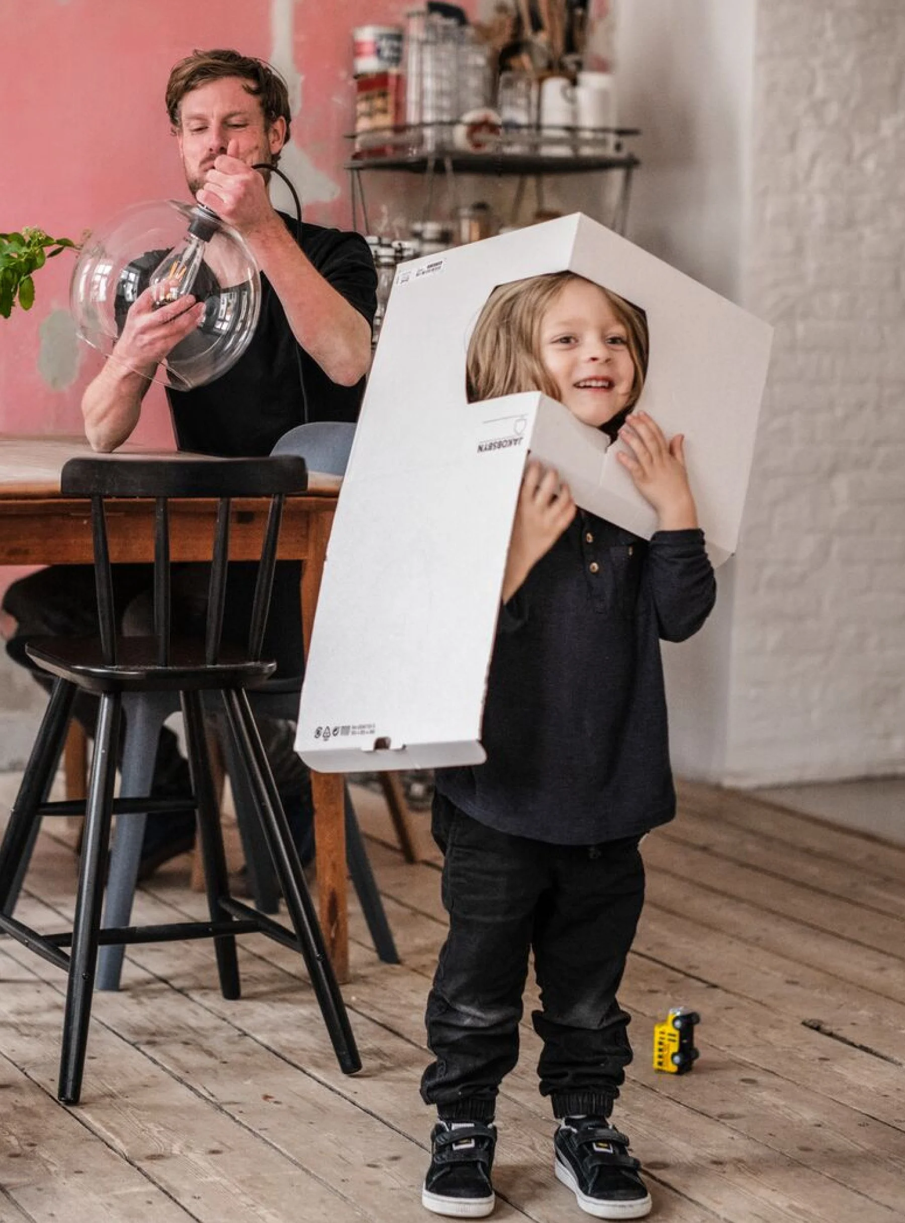 62d55fdd3ac530ac0485c3ba_ikea father and kid with packaging on head.jpg