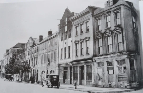 The buildings from 79 - 107 East Bay Street were originally designed as shops on the ground floor and residences above. 