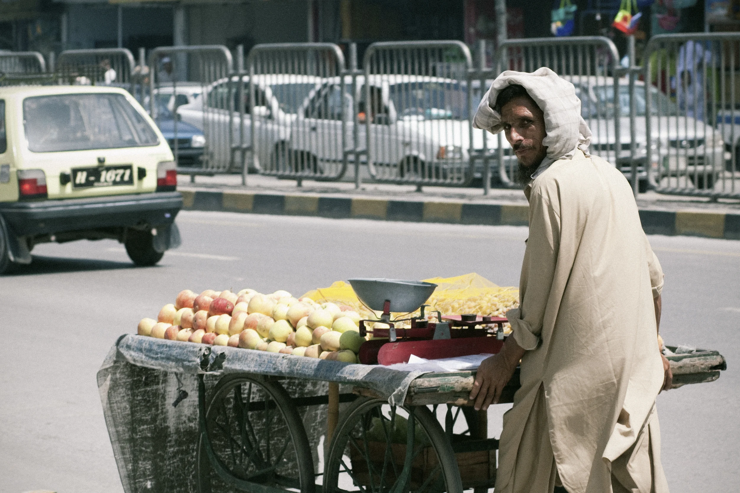 Rawalpindi, Pakistan - August 2010 : A fruit seller takes a second glance at a foreigner in his city.