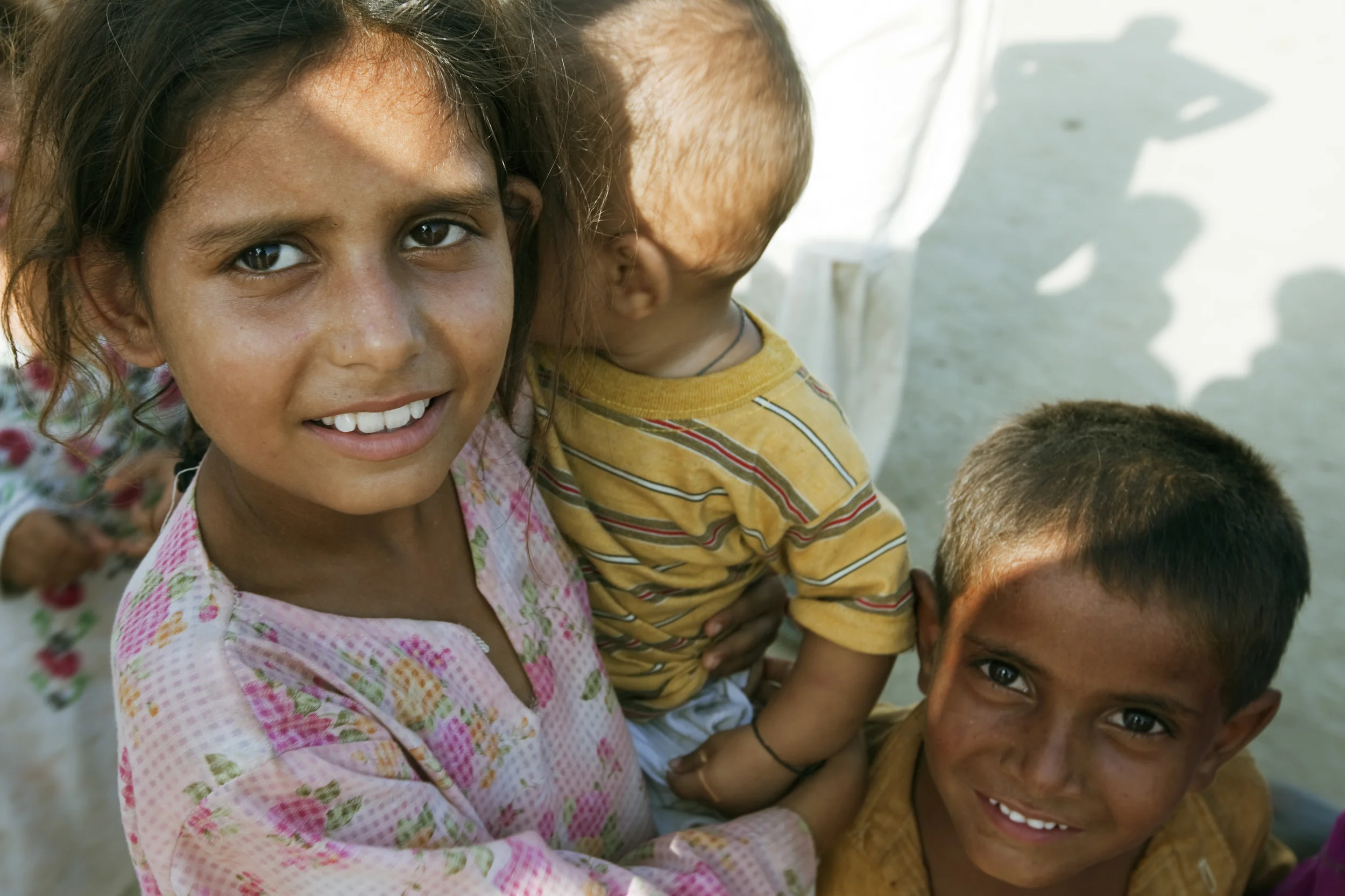 Charsadda, Pakistan - August 2010 : Sister taking care of her younger siblings.