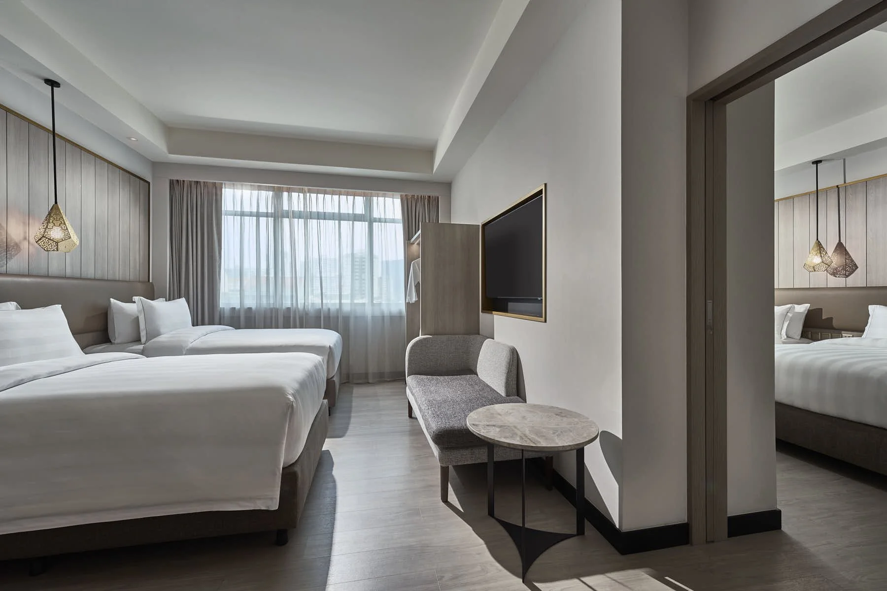 Spacious Novotel Singapore guest room with connecting room and modern minimalist decor.