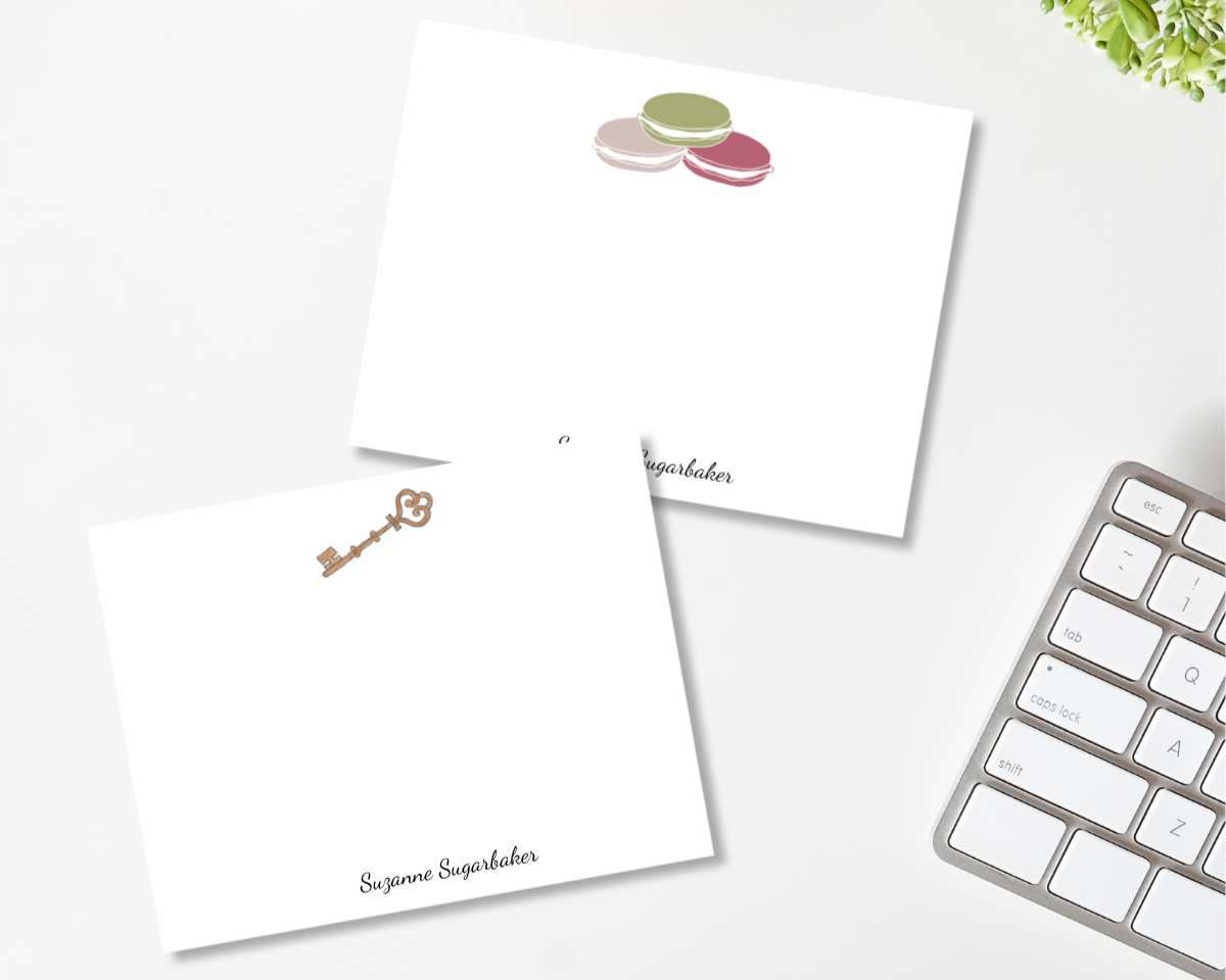 two notecards. one with an illustraion of and antique key at the top and one with french macaron cookies at the top both with the name "Suzanne Sugarbaker" at the bottom design by viola and beatrice stationers