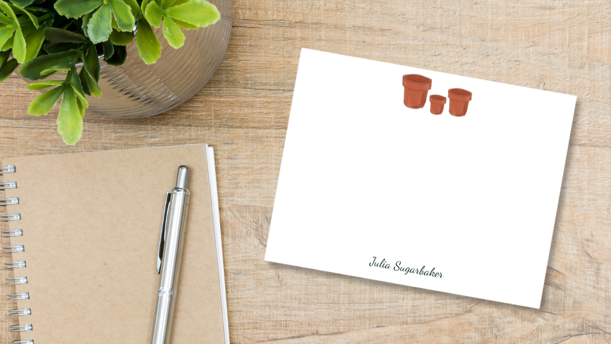 notecard with an illustrated set of three red clay pots on a desk designed by Viola and Beatrice Stationers