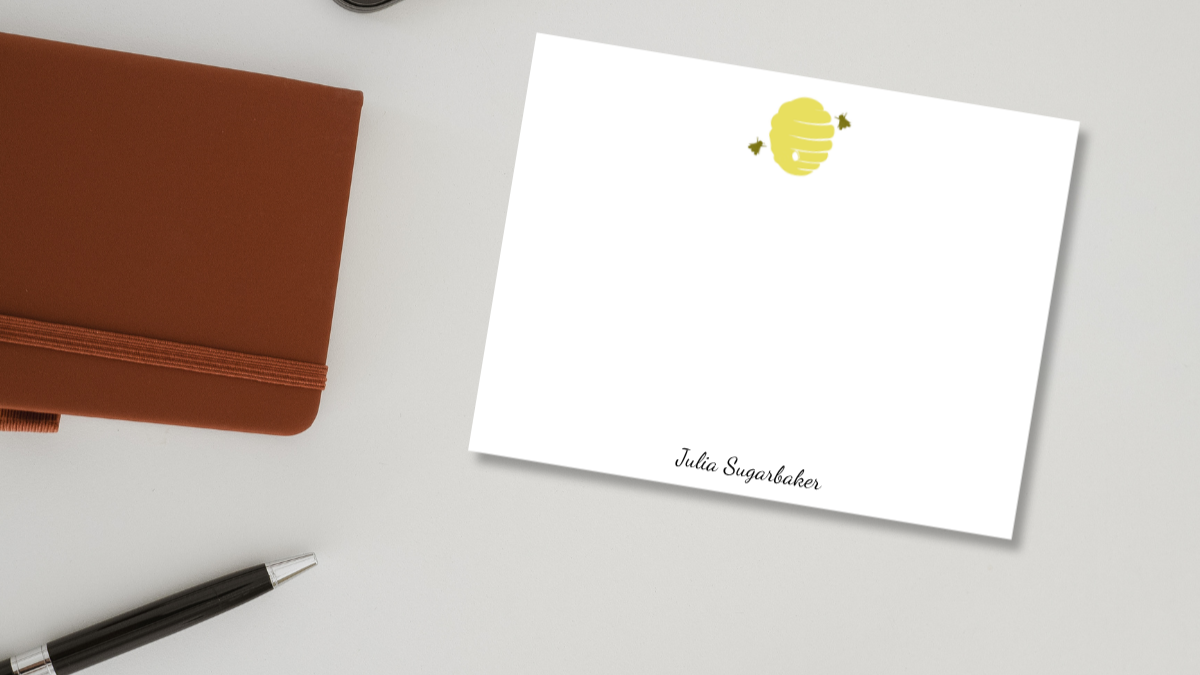 notecard with a bee hive, and a script name, Julia Sugarbaker, designed Viola and Beatrice Stationers