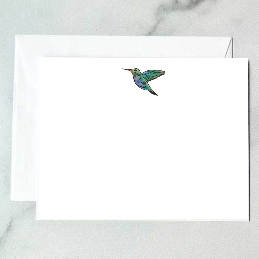 Illustrated hummingbird note card with a teal and green bird in mid-hover with wings spread wide on a clean white background, designed by Viola and Beatrice Stationers