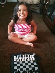 Ronald Olverson Jr. is teaching his granddaughter, Amaiya Villada, 3, how to play chess as part of his efforts to prepare her for college. (Photo: Provided)