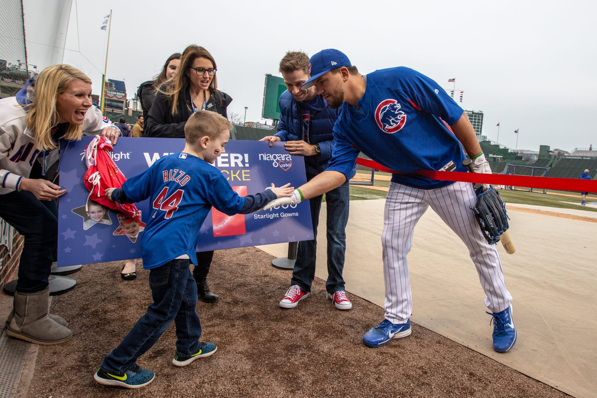  Jack throws opening pitch at Cubs game after winning Design-A-Gown contest. 
