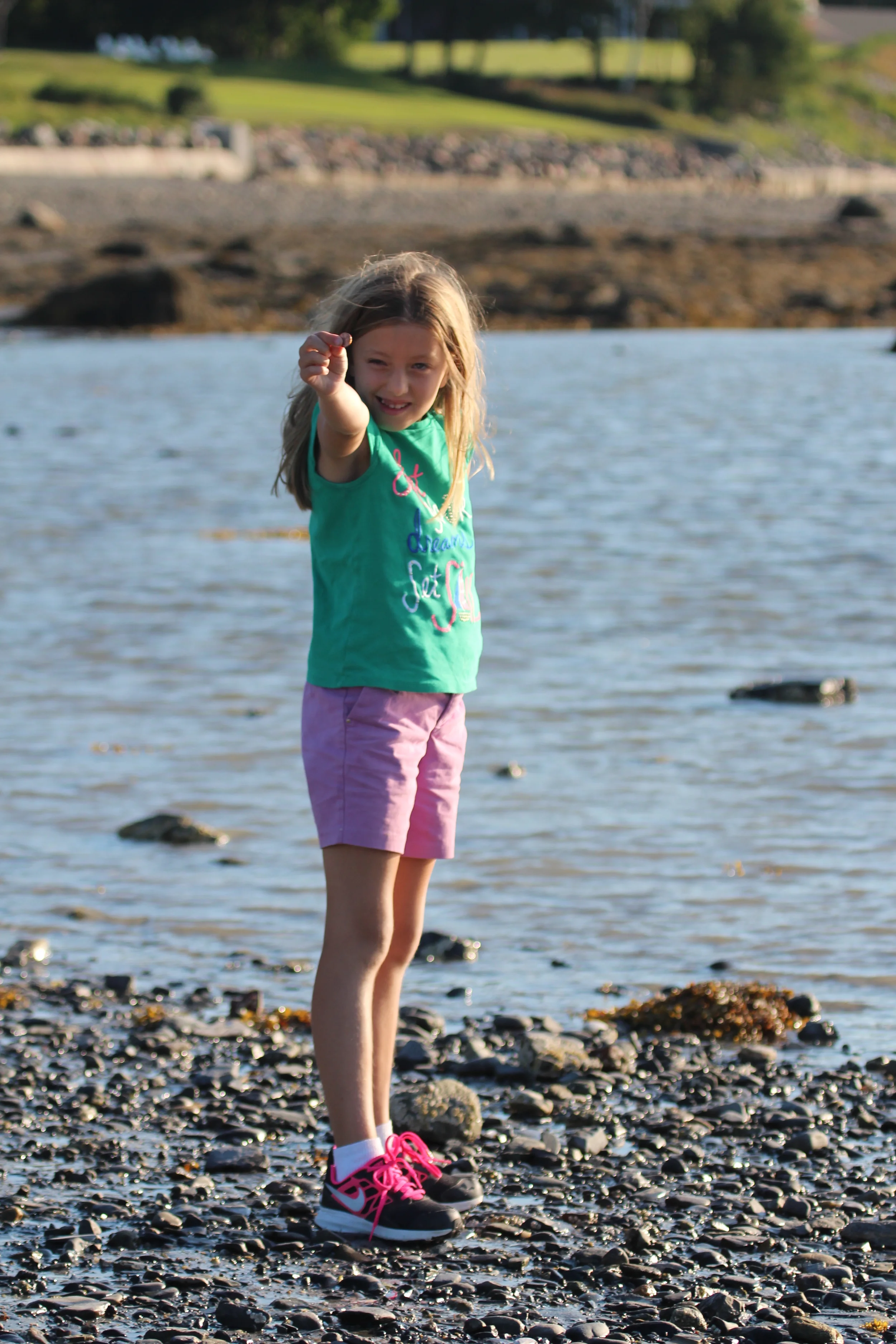 Showing off the great skipping rock she found to put her new found knowledge to the test.