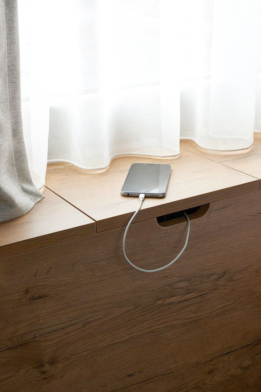 Detail / All rooms feature a wooden headboard with a hidden charger for your smart phone.