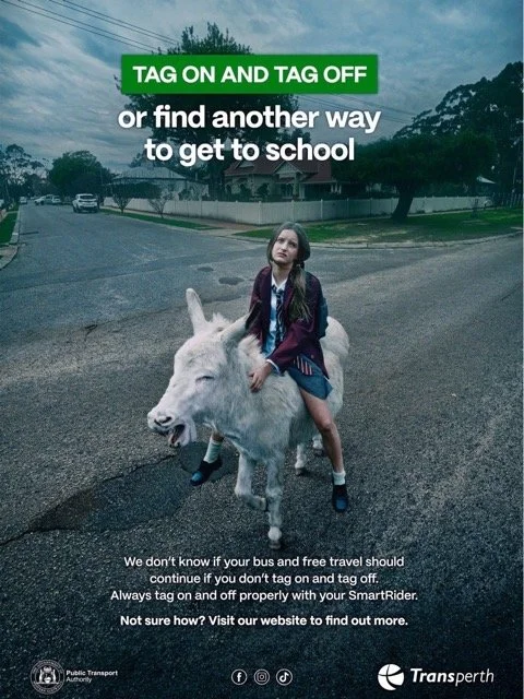 A girl riding a white sheep on a suburban street with trees and houses in the background. The image features text about tagging on and off your bus or travel. The logo of Transperth and the Public Transport Authority are visible at the bottom.