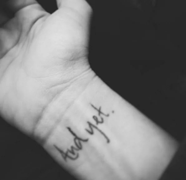My tattoo, "And yet." Description here .