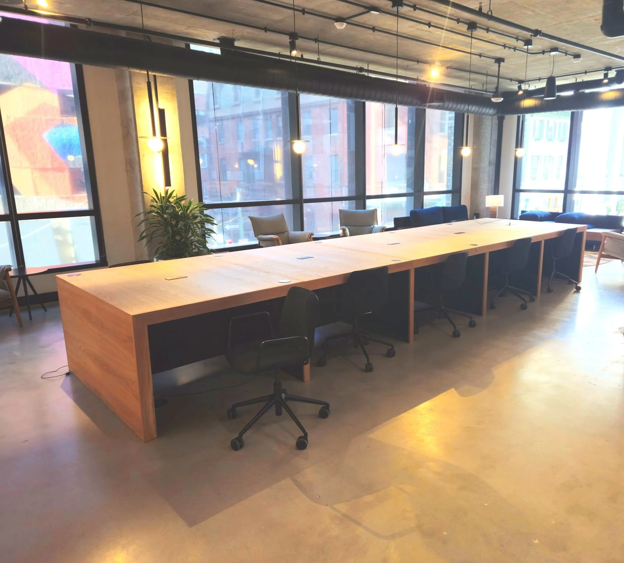 coworking office space table in white oak with charging ports parsons style seats ten people