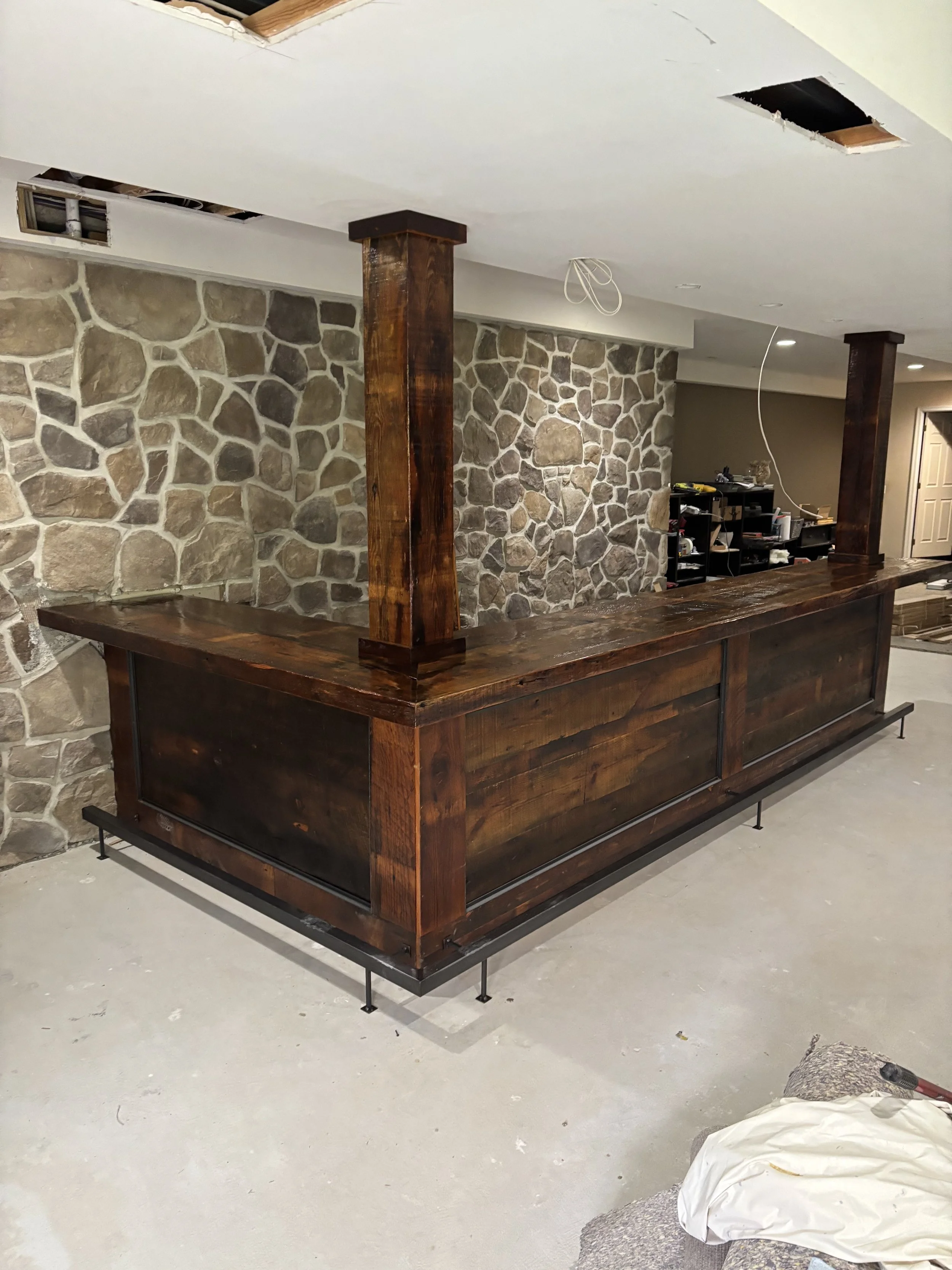 real wood basement bar, dark finish, custom rugged man cave bar