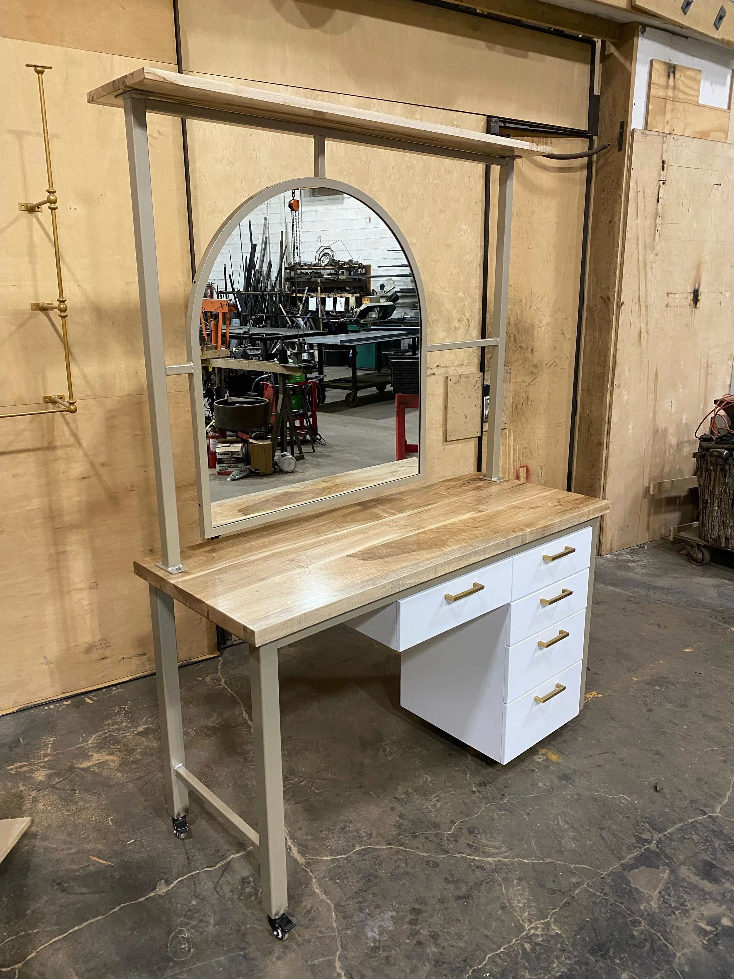 salon vanity with mirror and top shelf storage and drawers, gold and white design, arched mirror, custom woodwork custom metalwork baltimore maryland,